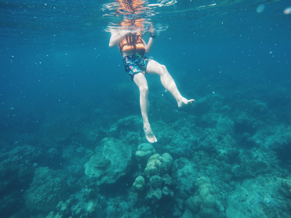 person's orange self flotation device