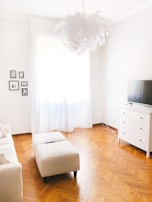 Bright and spotless living room with sunlight reflecting off polished surfaces.