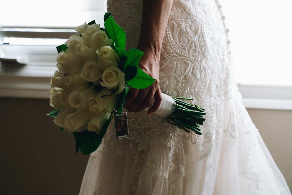 woman holding white rose bouquet
