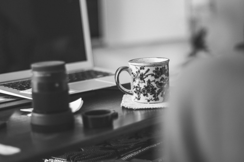 grayscale photography of white ceramic mug