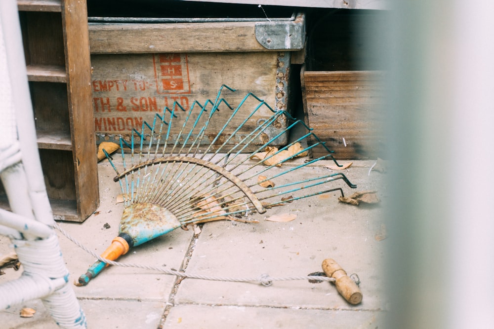 rake on pavement beside box