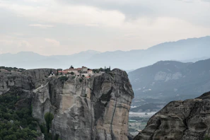 Window seat overlooking a peaceful monastery nestled in the hills.