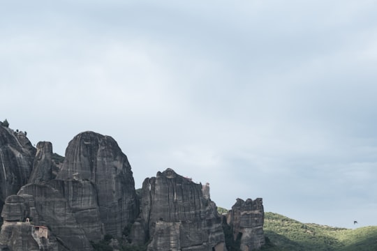 brown rocky mountain under cloudy sky during daytime in Meteora Greece