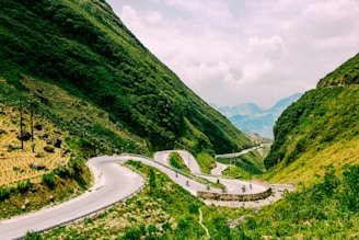 road leading to mountain under white sky