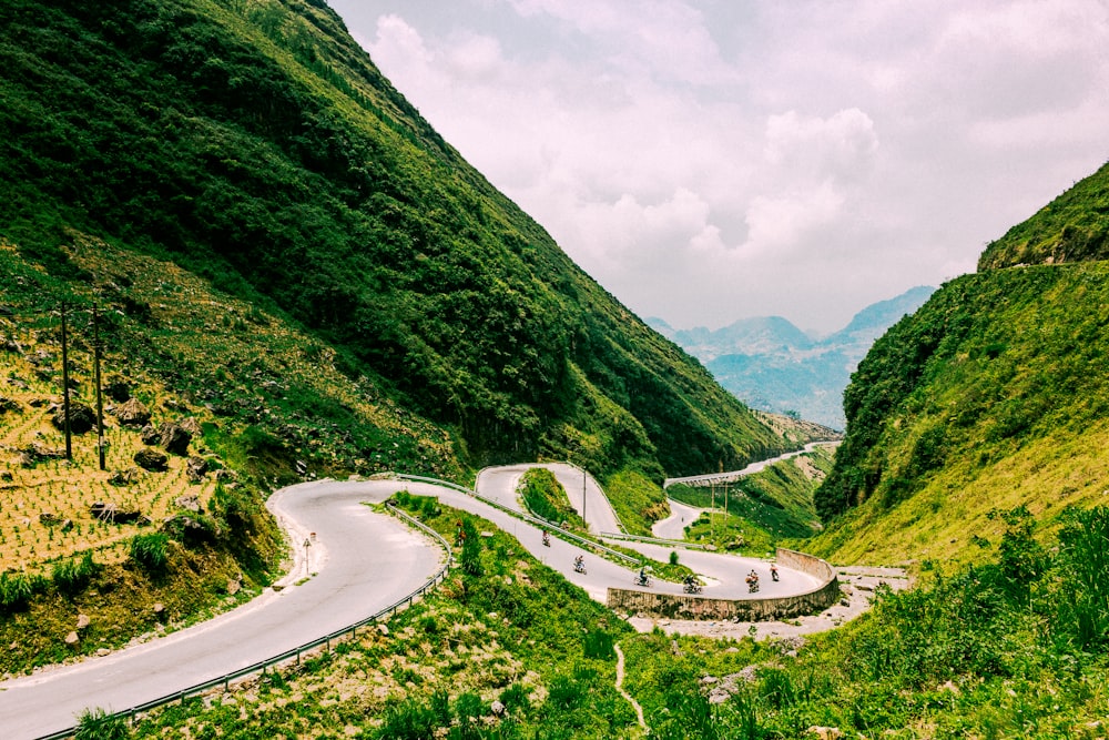 road leading to mountain under white sky