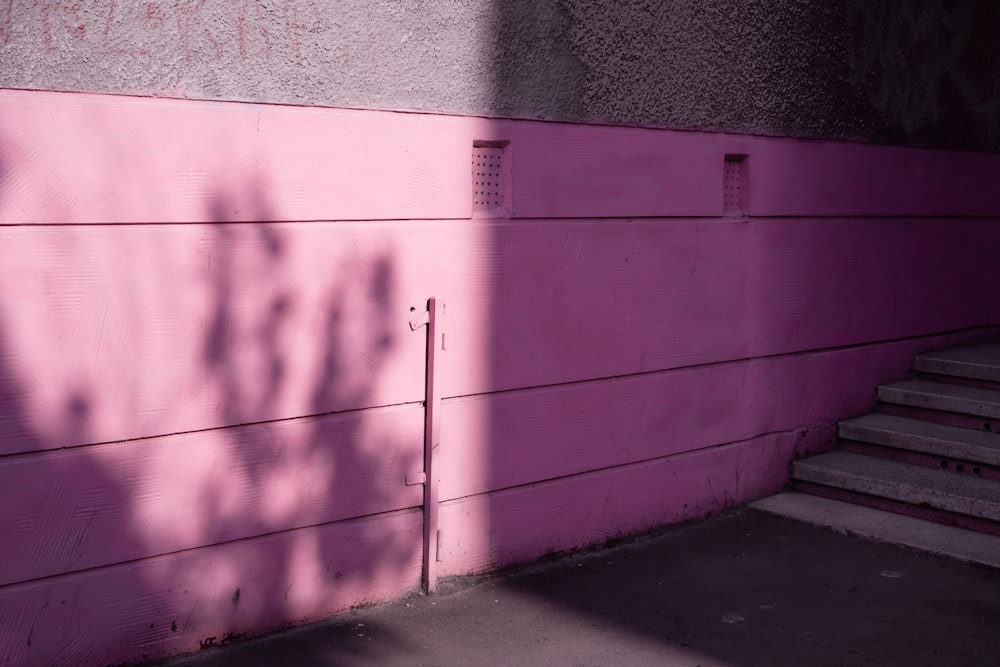 purple painted wall near staircase