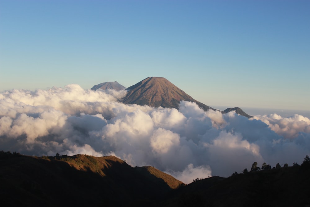 clouds under hill at daytime