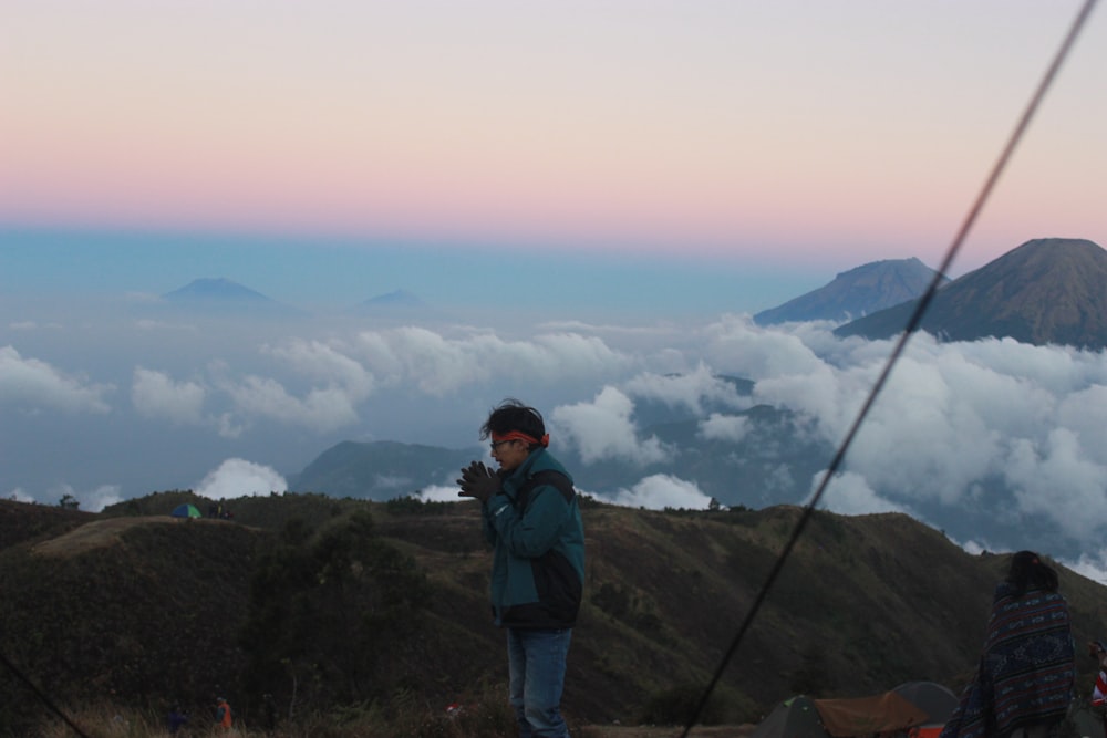 person standing at the top of mountain