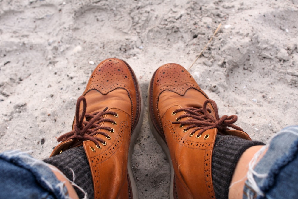 person wearing brown leather loafers