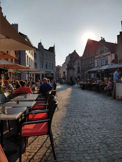 Sunset view over the town square with people enjoying an outdoor café atmosphere