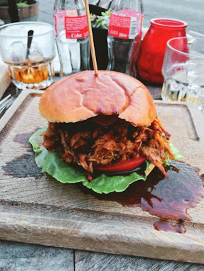 The pork sandwich showcasing tender, juicy pork with colorful Venezuelan toppings.