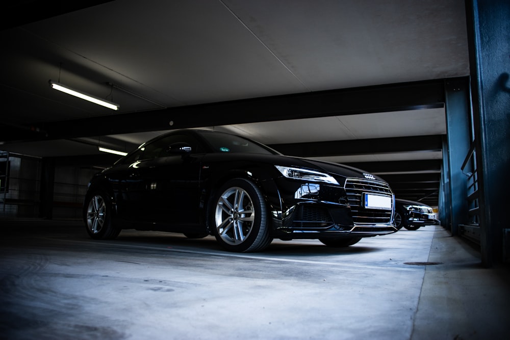 black Audi coupe parked on parking lot