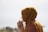 woman in brown headdress putting eyeglasses in tilt shift photography