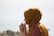 woman in brown headdress putting eyeglasses in tilt shift photography