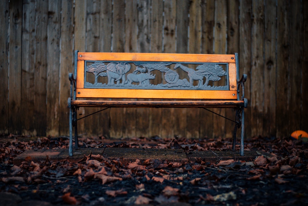 brown and black metal framed bench beside brown wooden fence