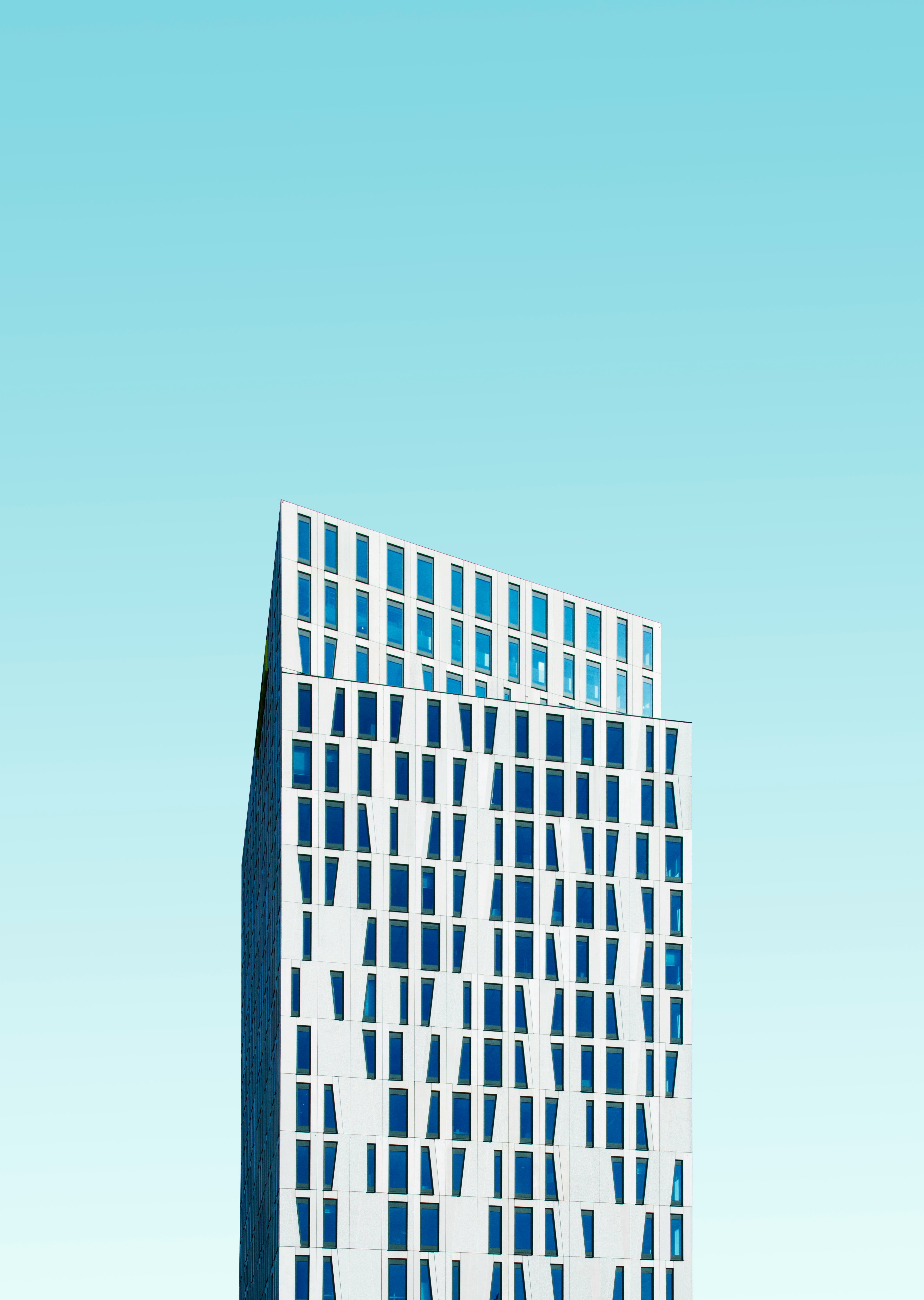 photo of white concrete building under blue sky at daytime