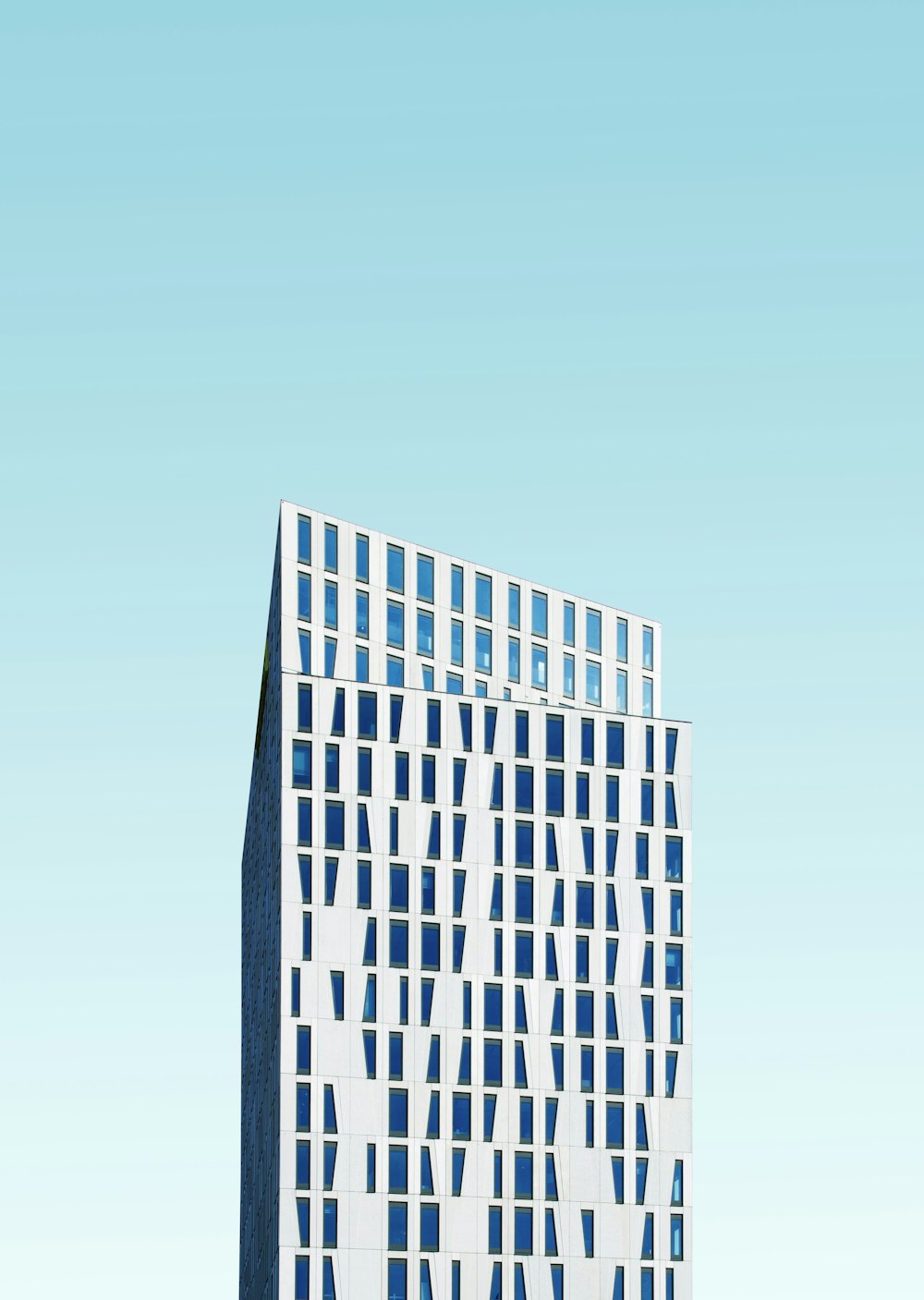 photo of white concrete building under blue sky at daytime