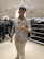 A satisfied customer wearing fashionable attire from Swiftstore.