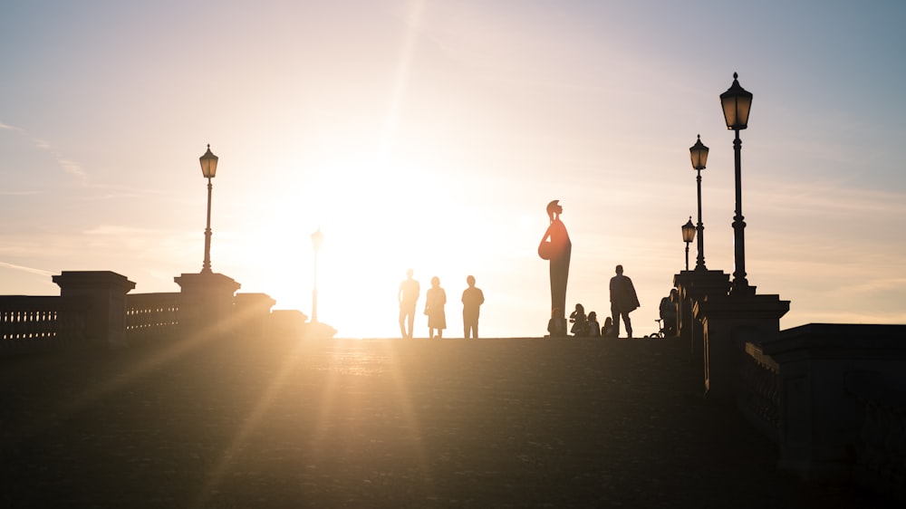 a group of people standing on top of a bridge