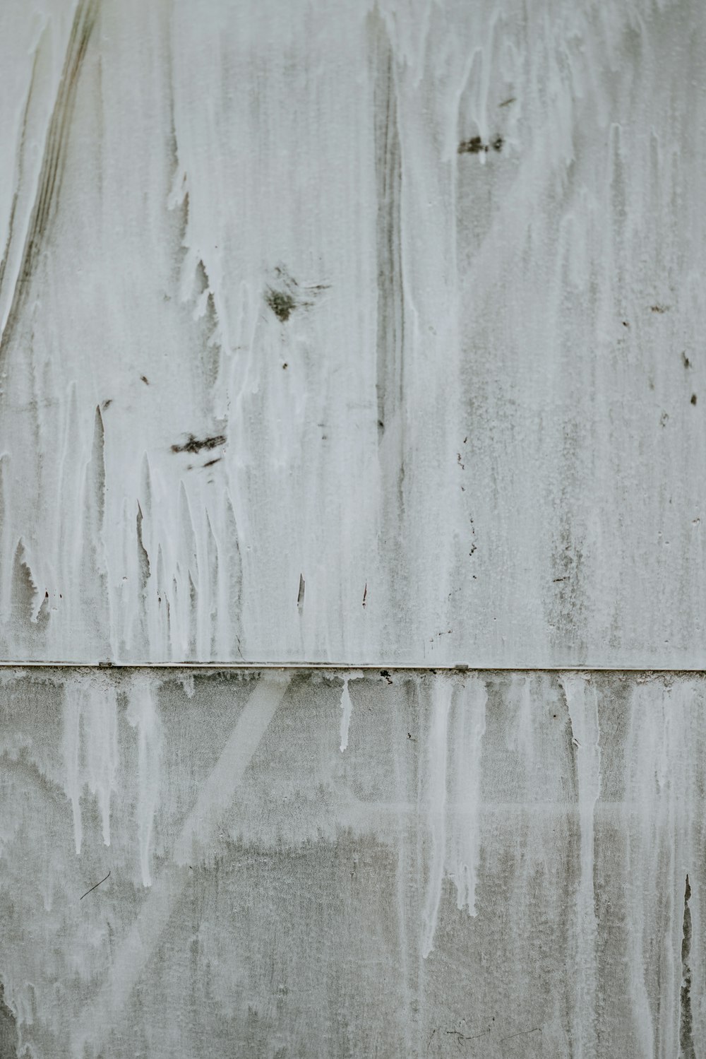 a red fire hydrant sitting in front of a wall covered in ice