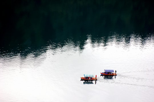 people on two boats on lake in Lake Bled Slovenia