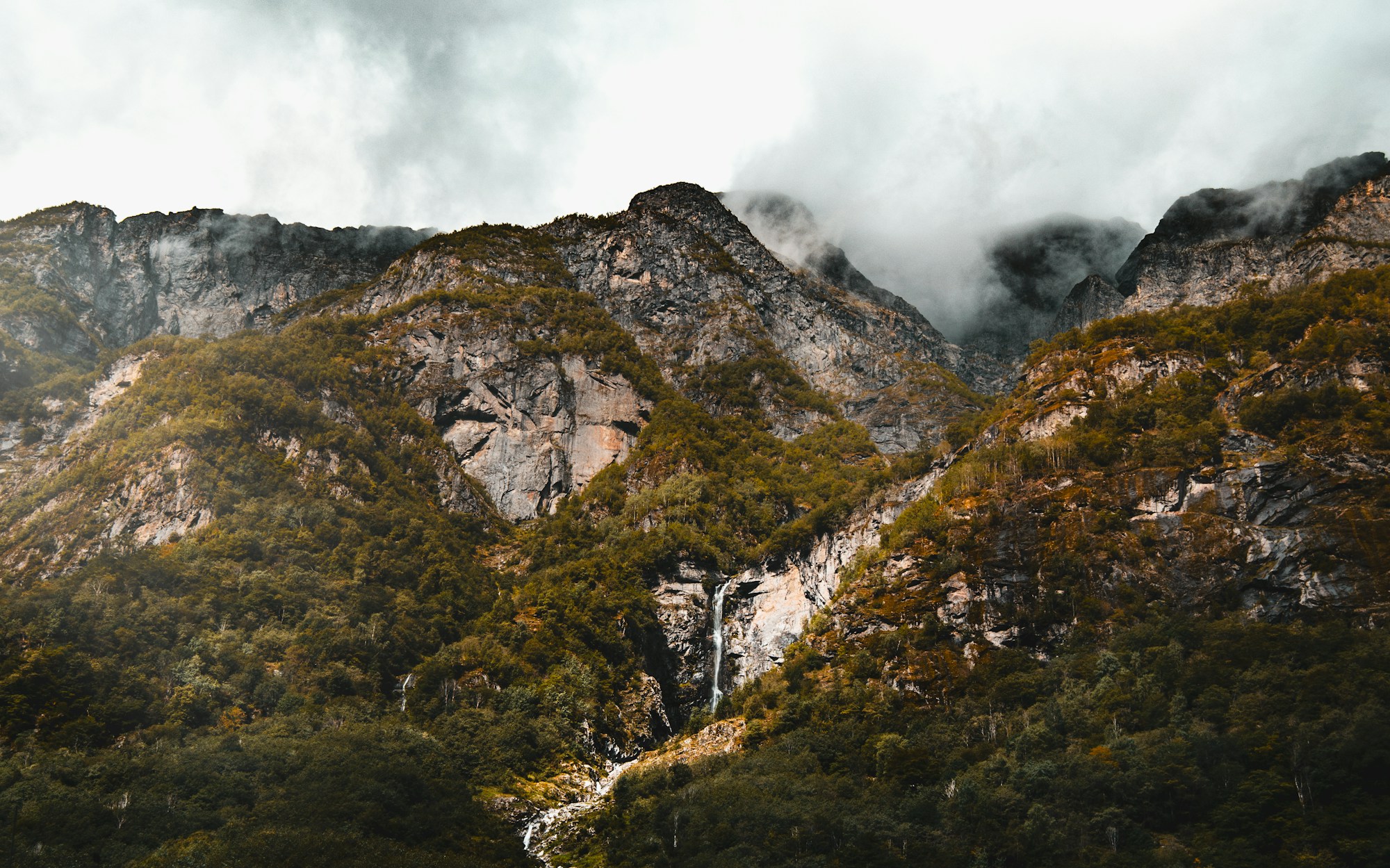 Cruising the Nærøyfjord in Norway with steep fjord walls and dramatic mountain scenery