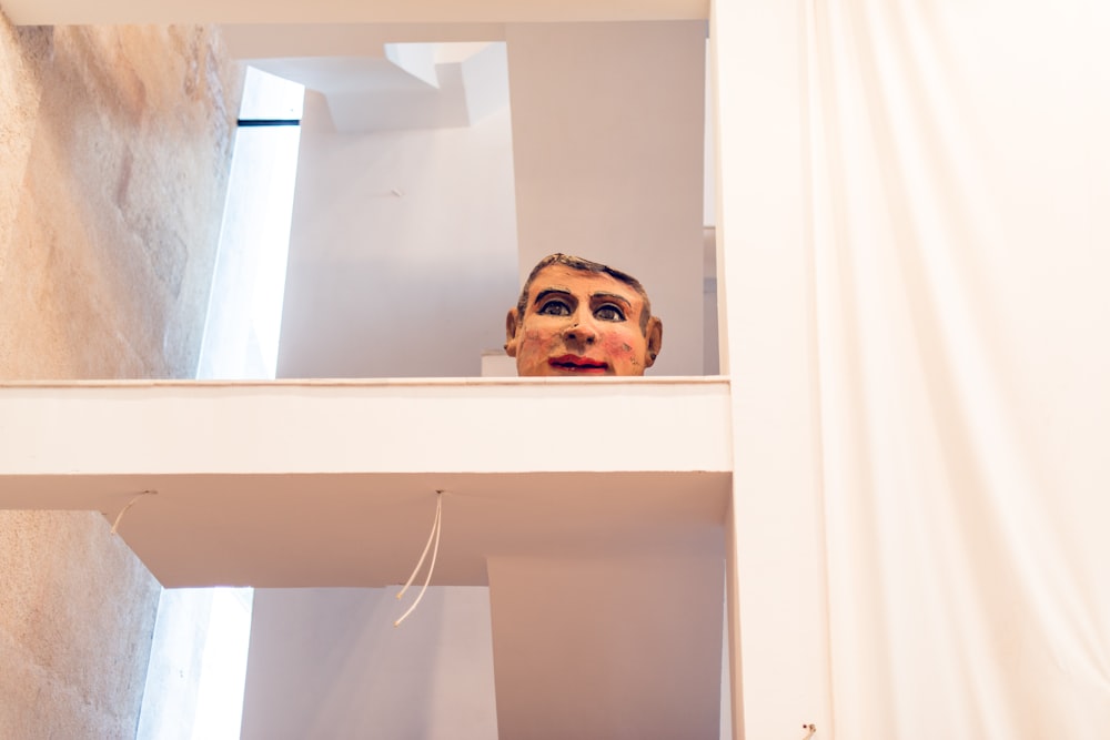 human face decor on shelf
