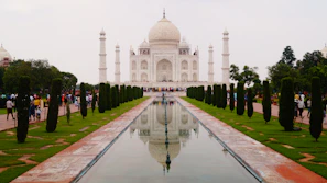 Tourists taking photos at the JK Memorial surrounded by lush greenery