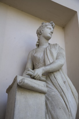 white concrete statue of a man