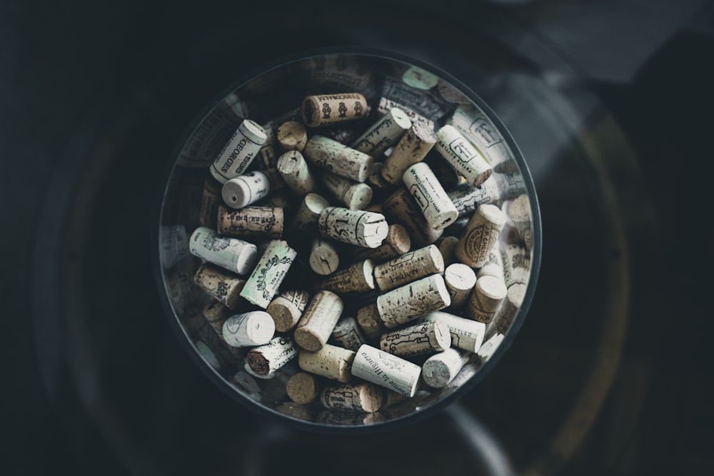 brown corks inside clear glass vase