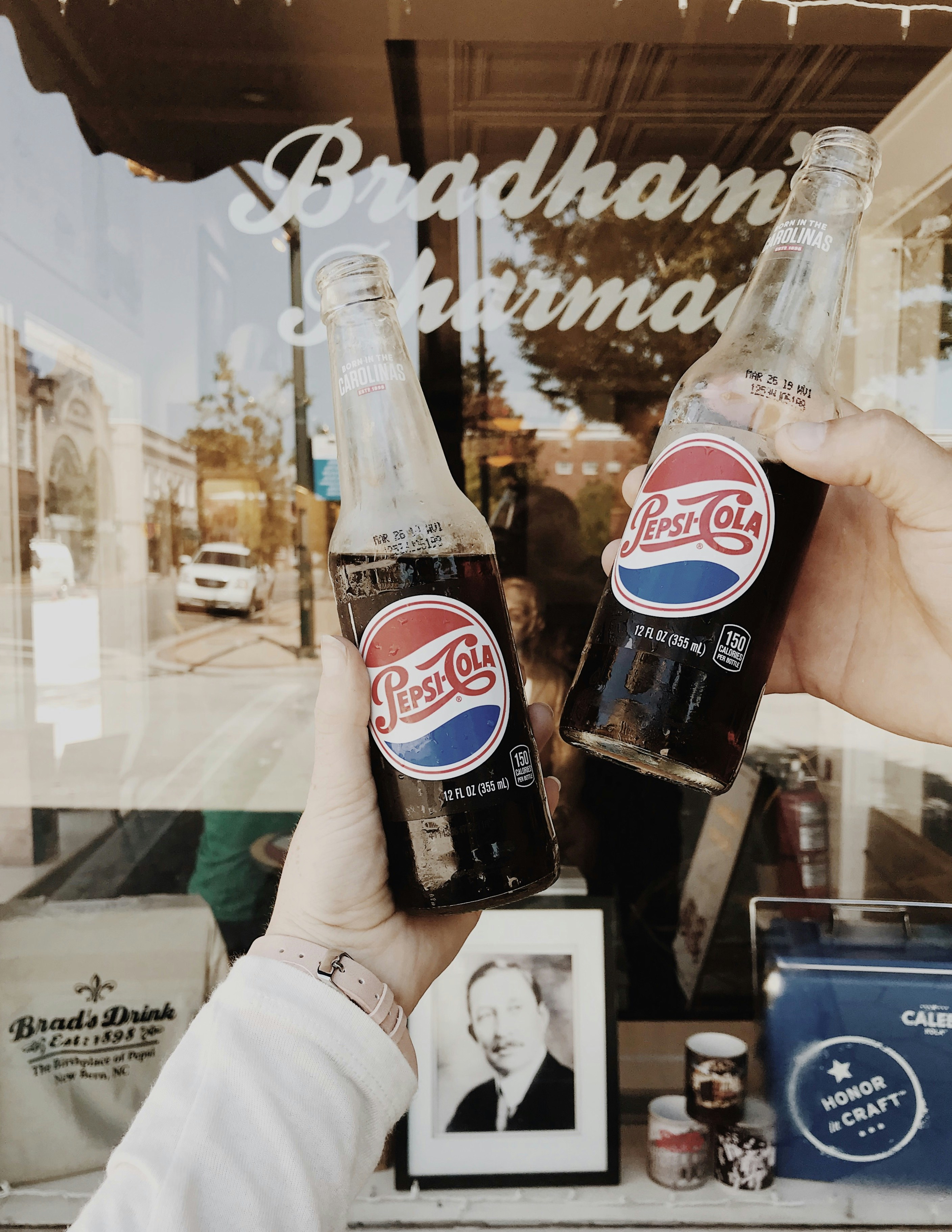 person holding Pepsi Cola soda bottles