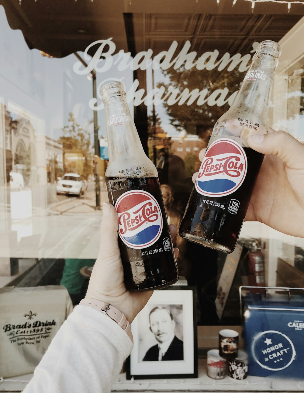 person holding Pepsi Cola soda bottles