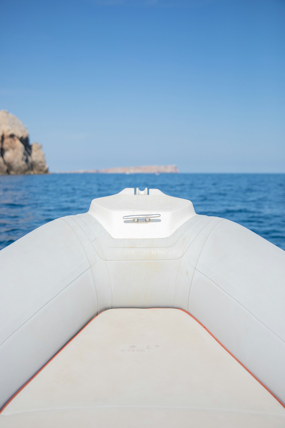 white boat on body of water during daytime