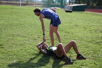 A grassroots athlete shaking hands with a brand representative in a sports stadium.