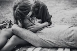 An intimate black and white shot of a family playing in a sunlit park.