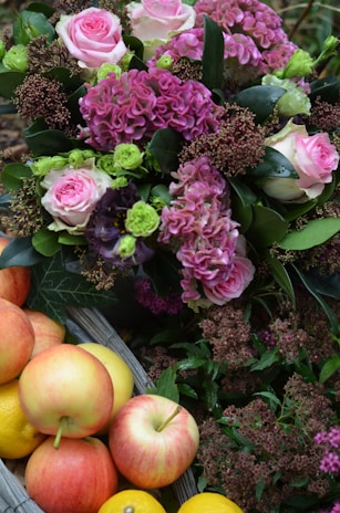 An elegant large gift basket filled with gourmet treats and fresh flowers.