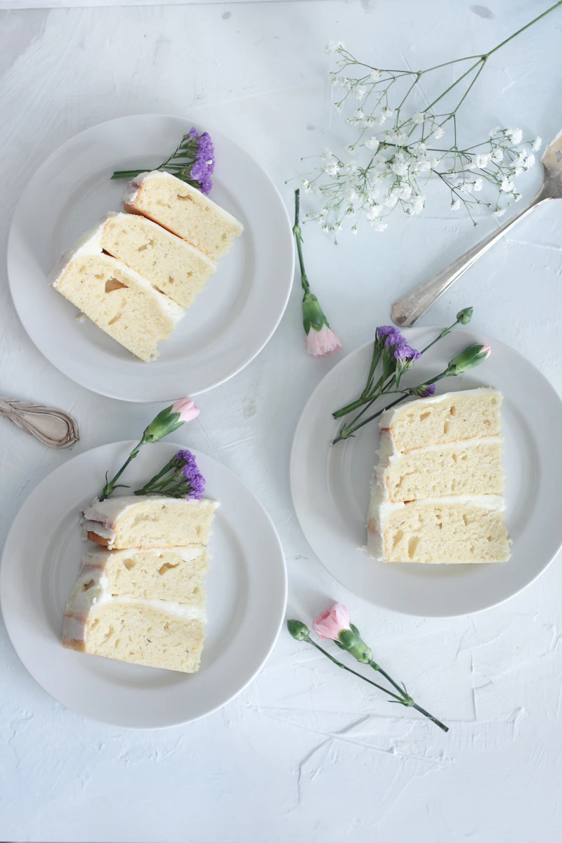 Overhead view of soft, moist vanilla cake slices on plates