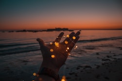 person with string lights on left hand