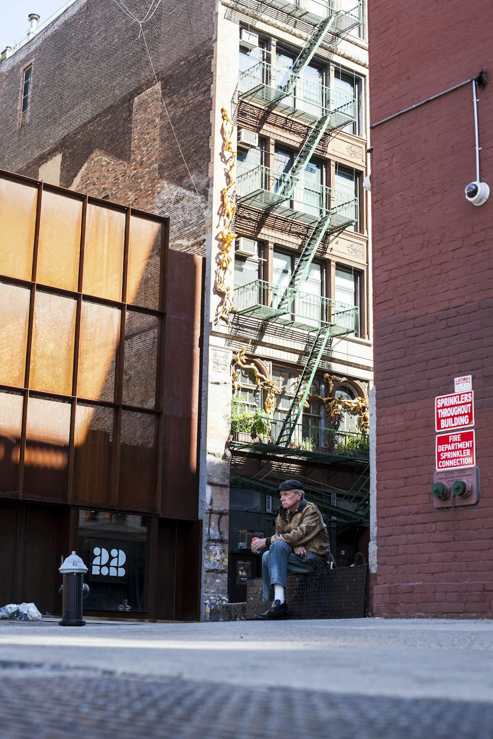 person sitting on bench beside building