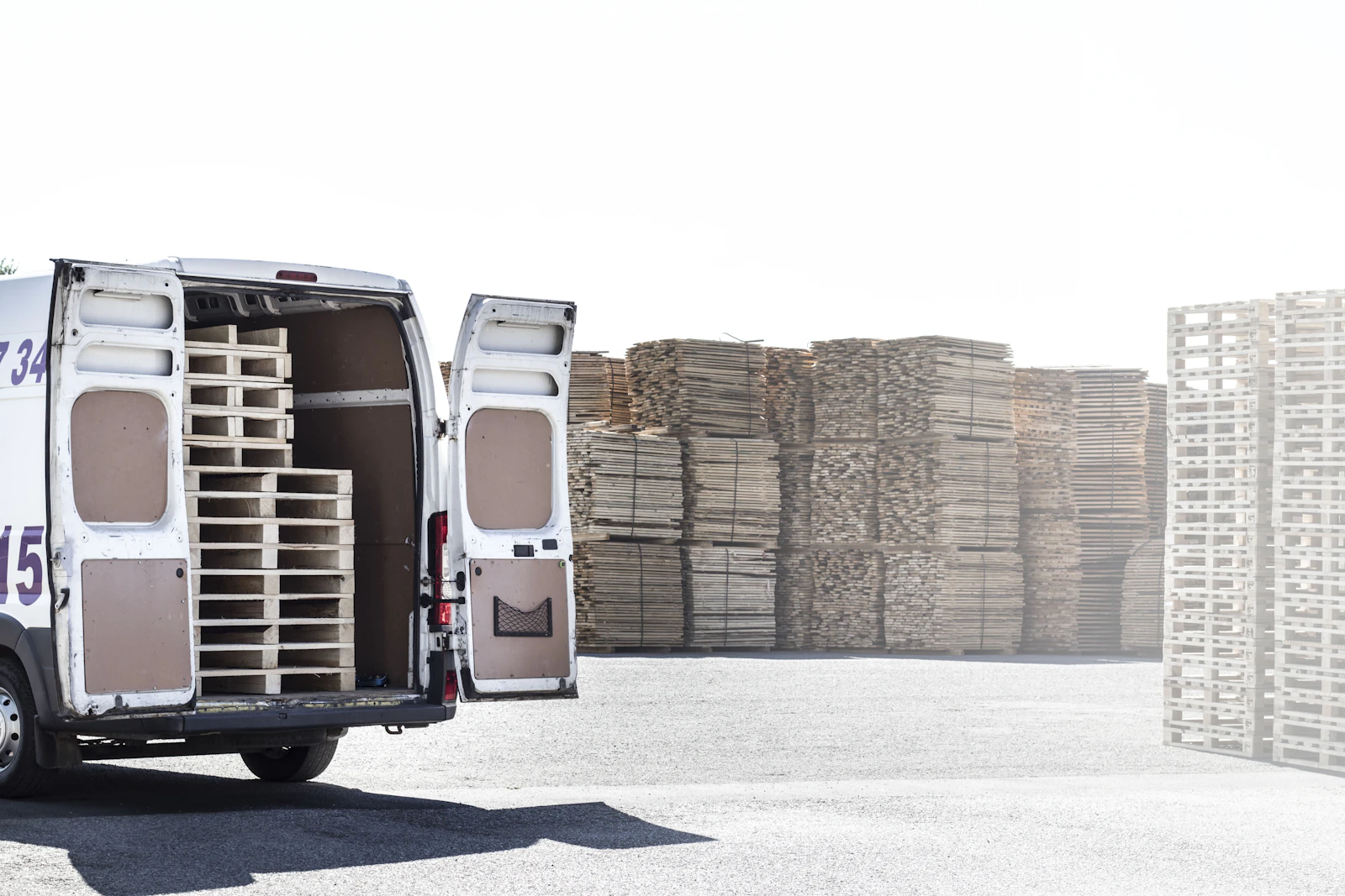 Stacked wooden pallets in a logistics yard