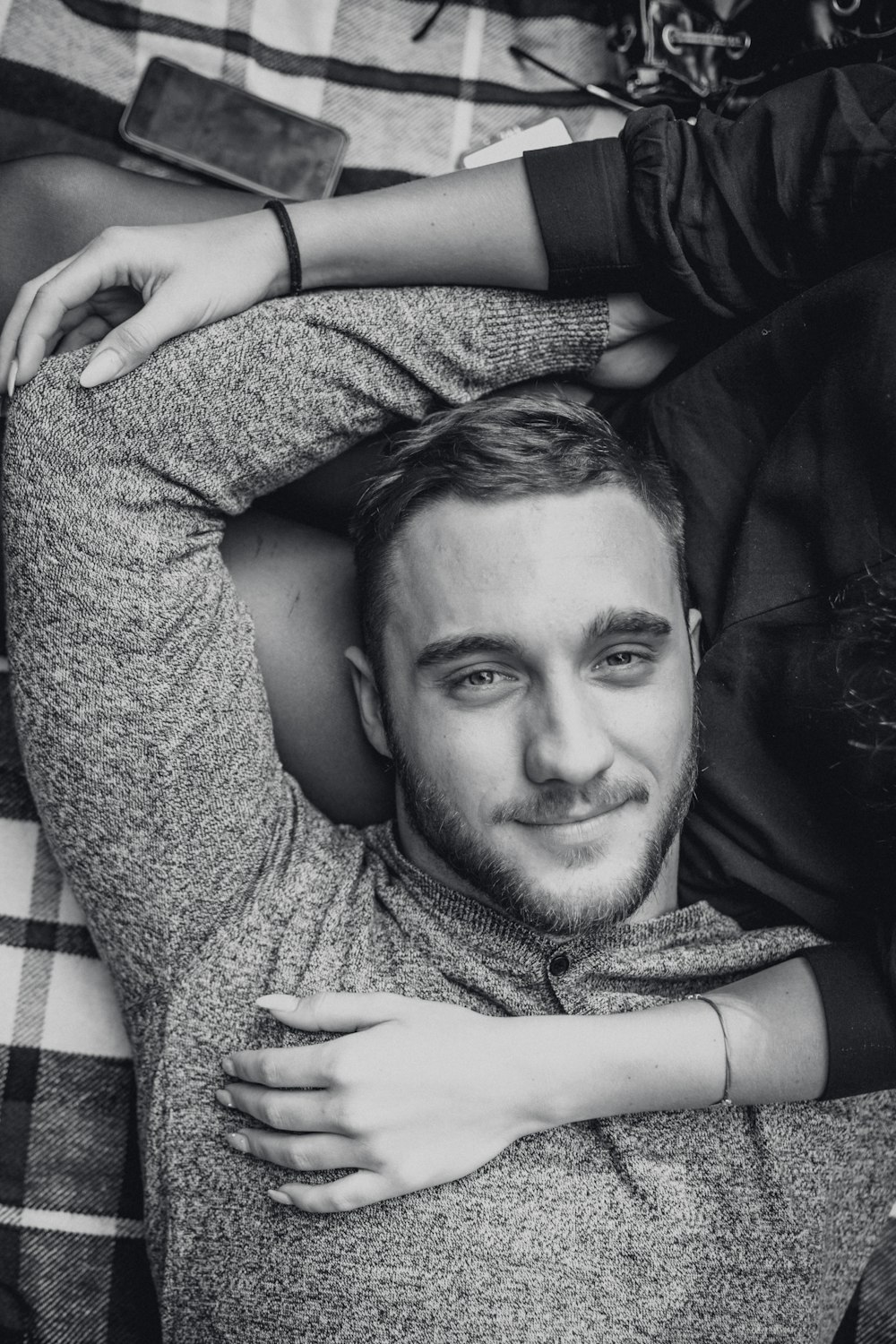 man laying down on woman's lap