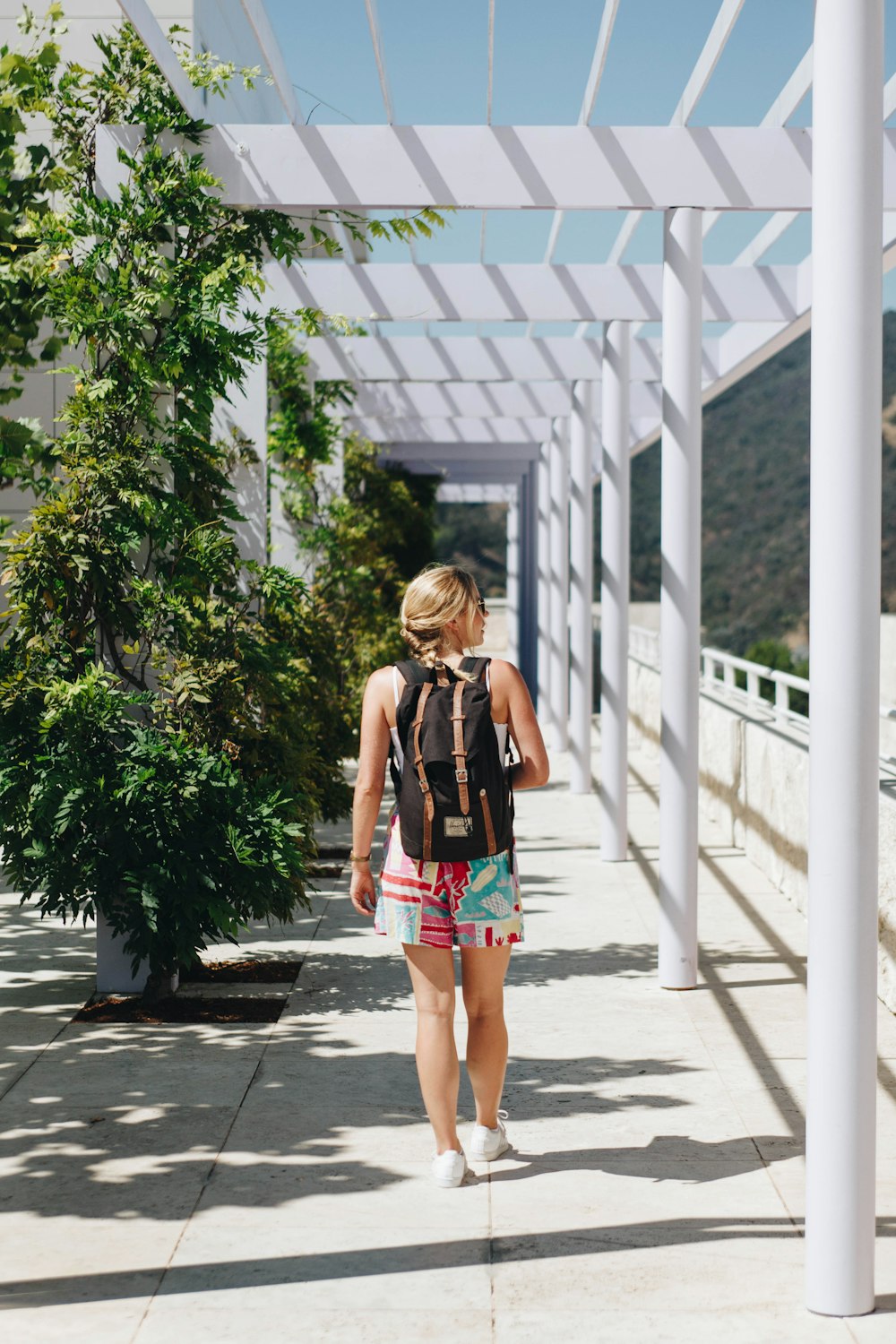 woman standing beside white fence