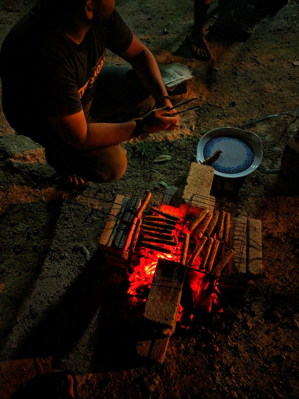 man sitting near grill