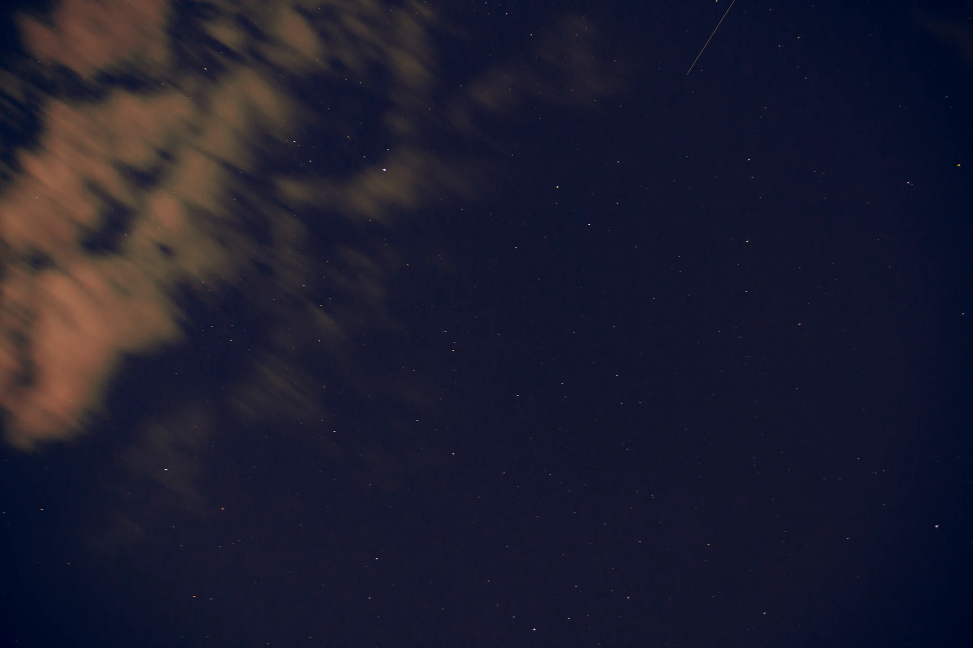 a plane flying in the night sky with stars