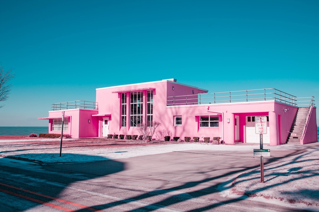 pink concrete building under clear blue sky