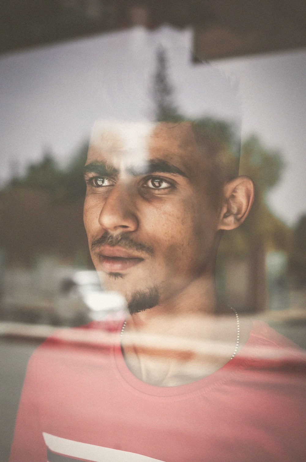 man standing in front of glass