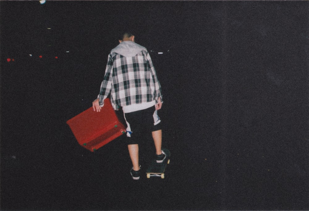 person putting his foot on skateboard