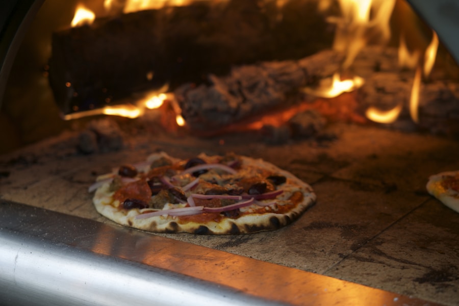 A pizza cooking inside the wood-fired oven