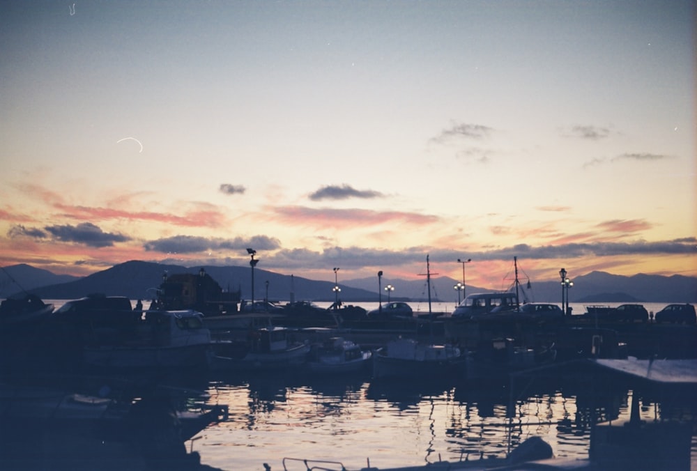 boats on body of water during sunset