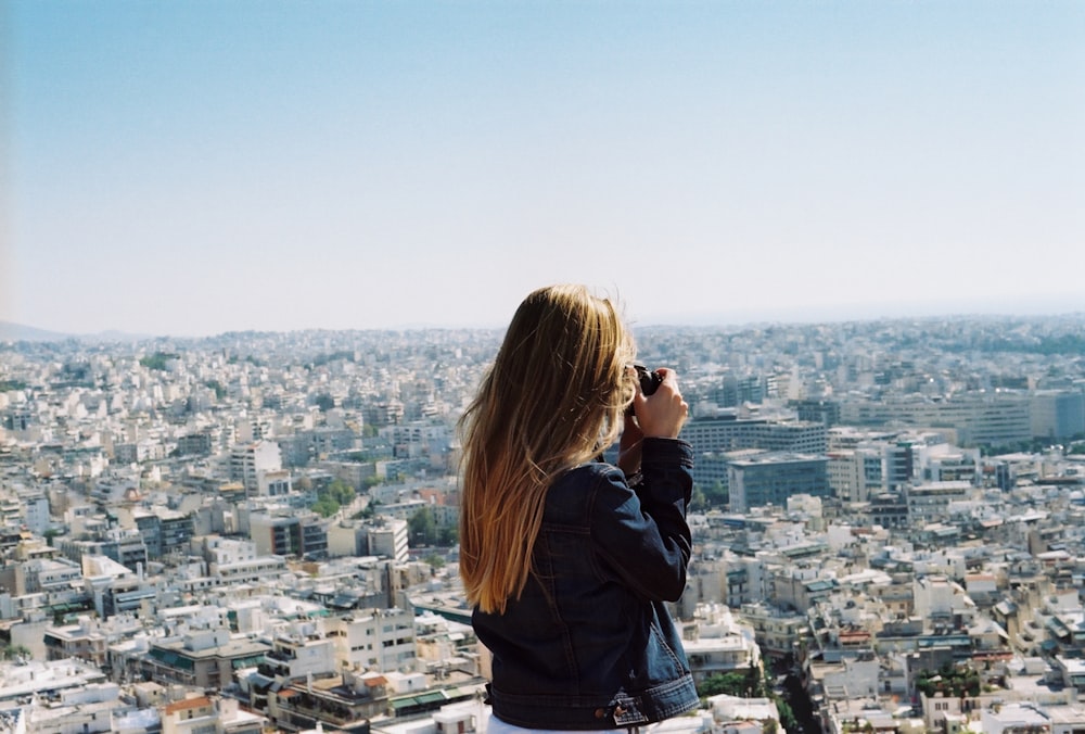 woman taking photo the city